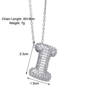 Detail view of silver letter I pendant necklace with size labels and pave cubic zirconia