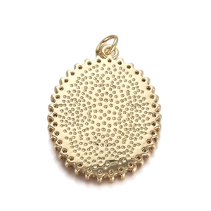 Golden oval pendant with textured finish and scalloped edges on a plain white background