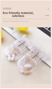 Detail of two transparent pill cutters with stainless steel blades on a desk