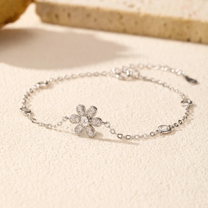 Elegant S925 sterling silver flower bracelet with sparkling crystals on a textured base