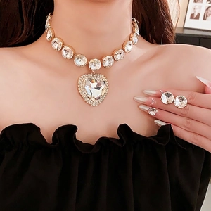 Luxury heart pendant necklace and round crystal earrings set in elegant gold finish