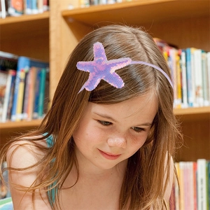 Cute kids headband with shiny purple sequin starfish on a thin lavender band