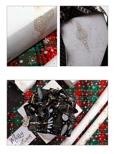 Macro detail of embossed Christmas wrapping paper with gold foil ribbons and festive cards