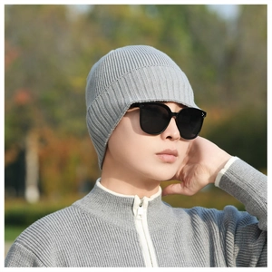 Detailed view of grey knit beanie with vertical ribbed texture and soft elastic fabric