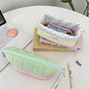 Detailed view of quilted fabric pencil cases with star pattern lining and zipper closure