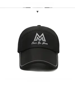 Detailed close-up of a black trucker hat featuring 3D M embroidery and mesh panels