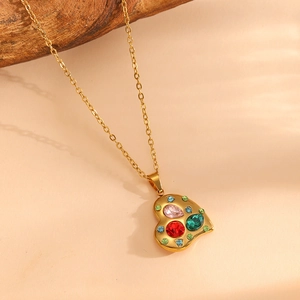 Detail of 18K gold-plated heart pendant with vibrant colorful multi-gemstone inlay