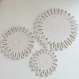 Three sizes of white round woven cotton rope trivets showing detailed spiral texture