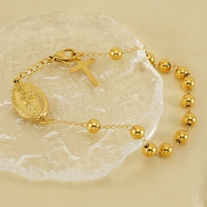 Golden stainless steel beaded bracelet featuring Virgin Mary medal and cross charm
