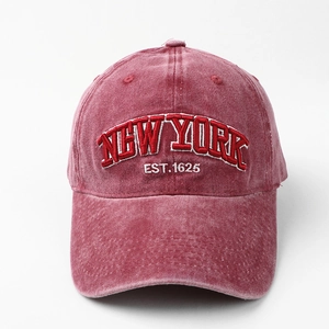 Close-up of 3D New York embroidery on washed denim burgundy red baseball cap