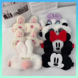 Detail view of various plush coral fleece sleep masks with cute rabbit and mouse designs