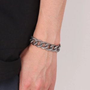 Macro detail of men's vintage titanium steel chain bracelet with intricate engraved textures
