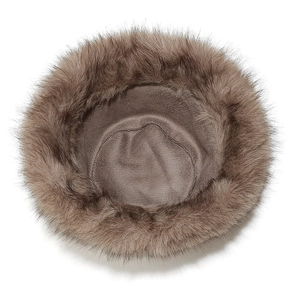 Close-up of brown faux fox fur hat showing dense plush texture and premium inner lining