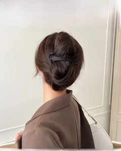 Elegant matte black minimalist hair clip styled in a classic updo bun for women