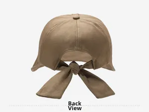 Detail view of khaki sun hat featuring a large adjustable bow tie back design