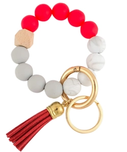 Detail of red silicone beads, wood bead, and tassel on the beaded keychain bracelet
