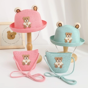 Close-up of kids bear ear straw hat and matching crossbody bag with cute embroidery