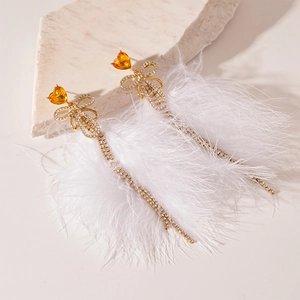 Elegant bow fringe earrings featuring orange heart gems and white feather accents