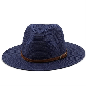 Detailed texture of dark blue straw fedora hat featuring a brown leather decorative band