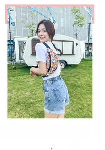 Asian model wearing a stylish crossbody chest bag with colorful street graffiti patterns