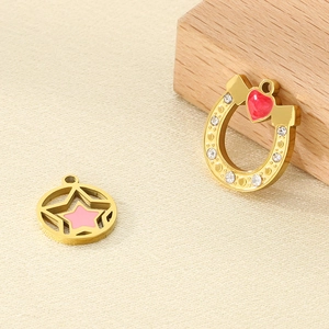 Detail of gold star and heart charms with pink inlay and sparkling crystal rhinestones