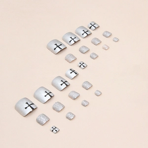 Silver glitter and metallic press-on toenails with black cross design in 24-piece set