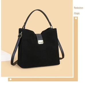 Detail view of the black suede handbag with premium gold buckle and leather strap