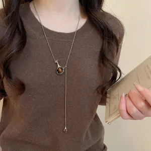 Minimalist silver Y-shaped long necklace with brown tiger-eye textured spherical pendant