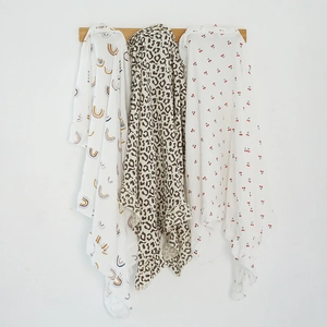 Three-piece set of muslin cotton baby swaddle blankets with rainbow, leopard, and cherry prints