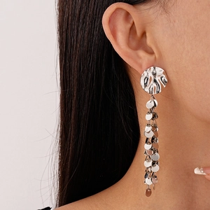 Elegant silver tassel earrings with metallic sequins on a model for a chic look