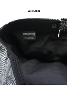 Detailed close-up of 100% cotton care label inside a black and white checkered beret cap