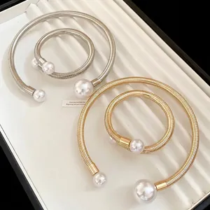Metallic pearl necklace and bracelet set in gold and silver with large pearl accents