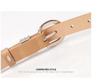 Detail of beige faux leather belt featuring a silver circular metal buckle for formal suits