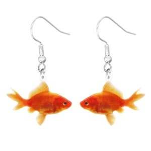 Macro shot of cute goldfish-shaped acrylic earrings with vibrant red and orange tones