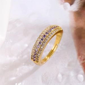 Macro shot of gold adjustable ring with alternating purple and white zircon inlay