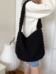 Large black bubble textured tote bag with wide shoulder strap for casual daily use