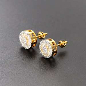 Detailed macro view of gold round stud earrings with micro-paved sparkling cubic zirconia