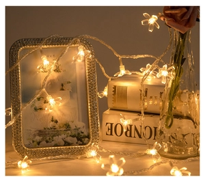 Close-up of warm cherry blossom LED string lights decorating a cozy home scene