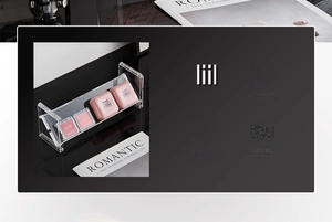 Close-up of clear acrylic makeup organizer with removable dividers for cosmetic storage