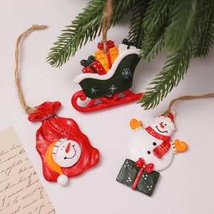Detailed view of resin Christmas tree ornaments including sleigh and snowman designs