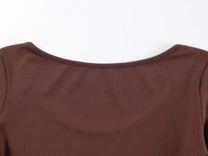Close-up of the smooth U-neckline and fine knitted texture of this brown cotton bodysuit