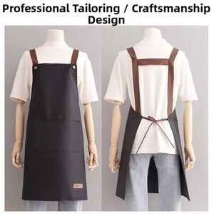 Industrial black apron with adjustable brown H-straps and large front pocket detail