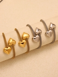 Detail of adjustable heart charm mesh bracelet in gold and silver stainless steel