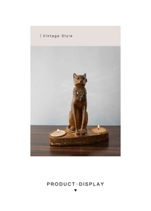 Detail of Egyptian cat candle holder with burning tealights and hieroglyphs