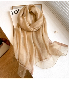 Detailed texture of beige silk wool blend scarf with subtle metallic pinstripes