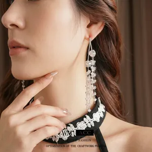 Elegant silver tassel earrings featuring multi-layered chains and crystal glass pendants
