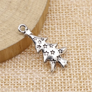 Silver Christmas tree pendant with star relief and hanging loop on rustic background