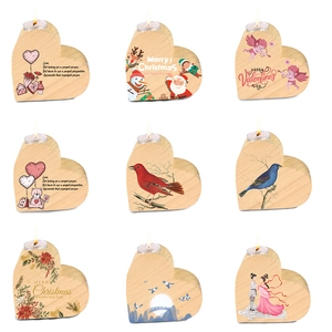 Nine heart-shaped pine wood candle holders with festive prints and metal inserts