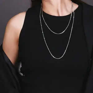 Double-layered silver snake chain necklace set for women worn by a fashion model