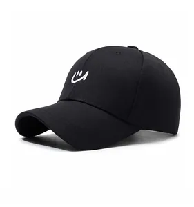 Close-up of a black baseball cap with white smile embroidery from a 45-degree angle
